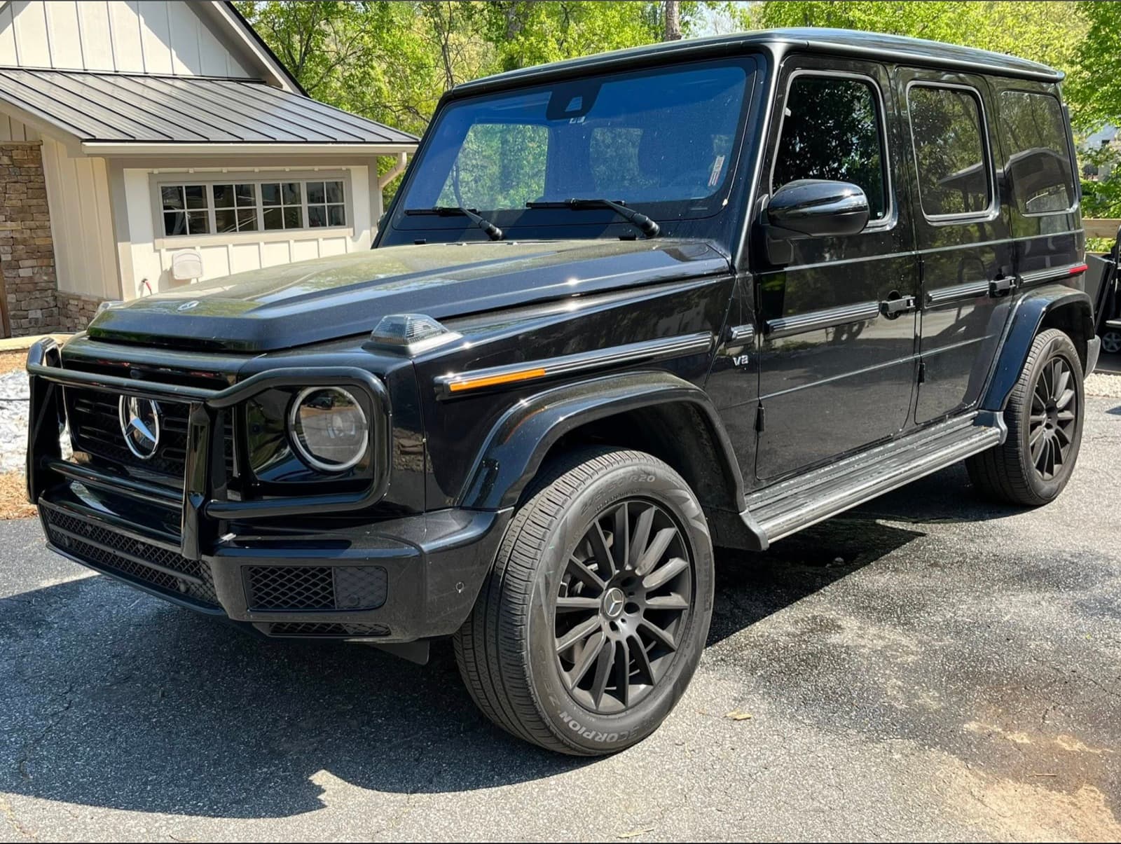 Freshly detailed black Mercedes-Benz G-Class in a Stilwell driveway after a LuxDetails signature exterior service.