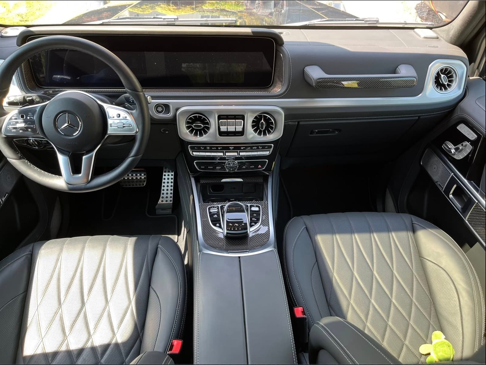 Interior cockpit of a Mercedes-Benz G-Wagon with quilted leather seats after a signature interior detail.